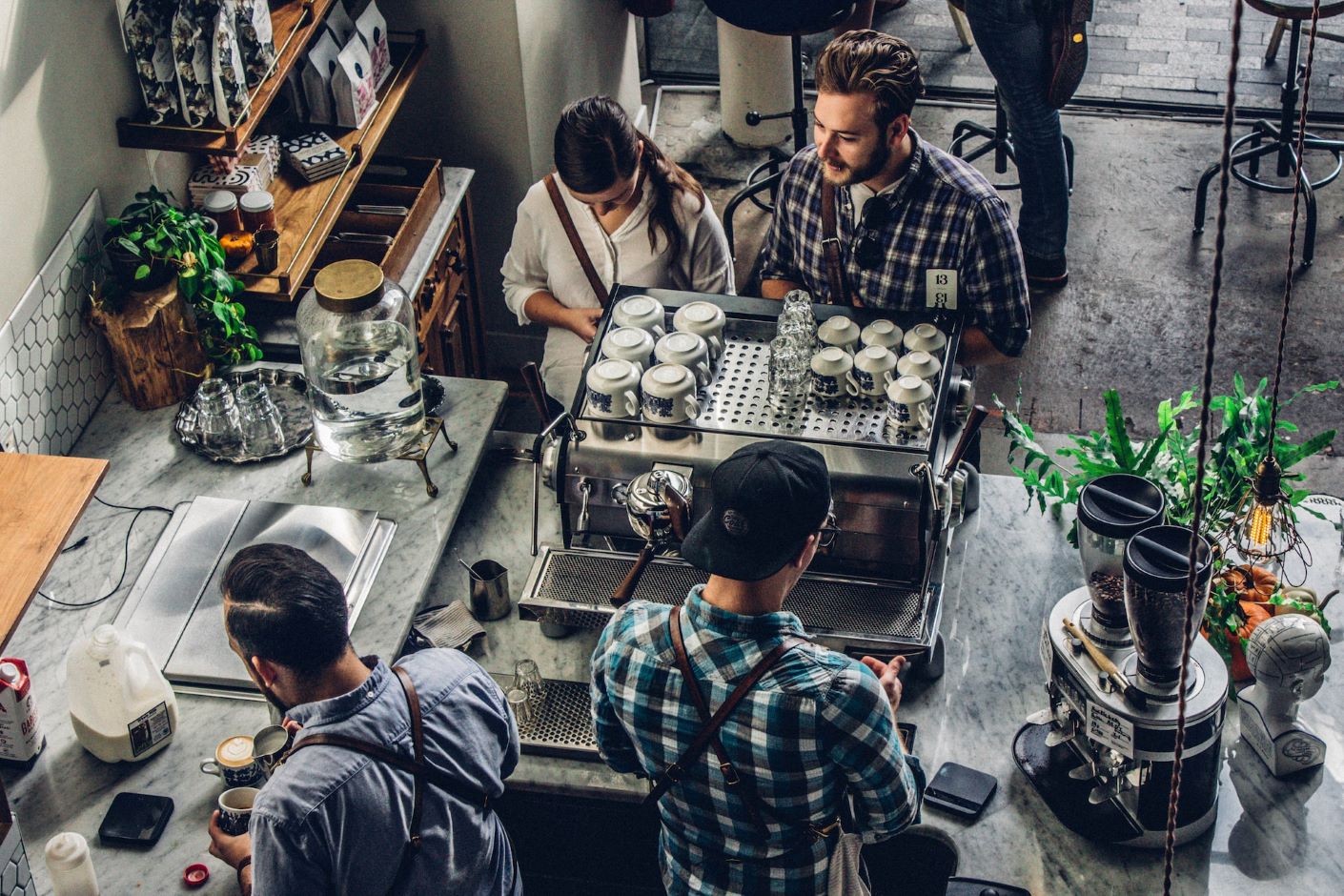 Baristas making coffee for customers