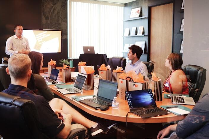 Business team reviewing charts on a screen in a conference room