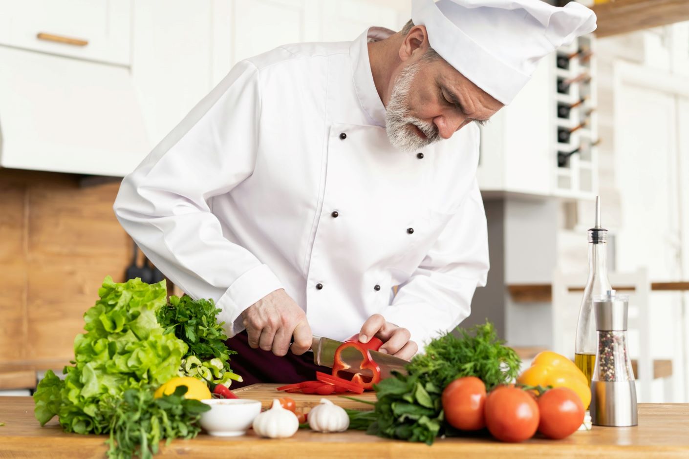 Chef cutting a red pepper