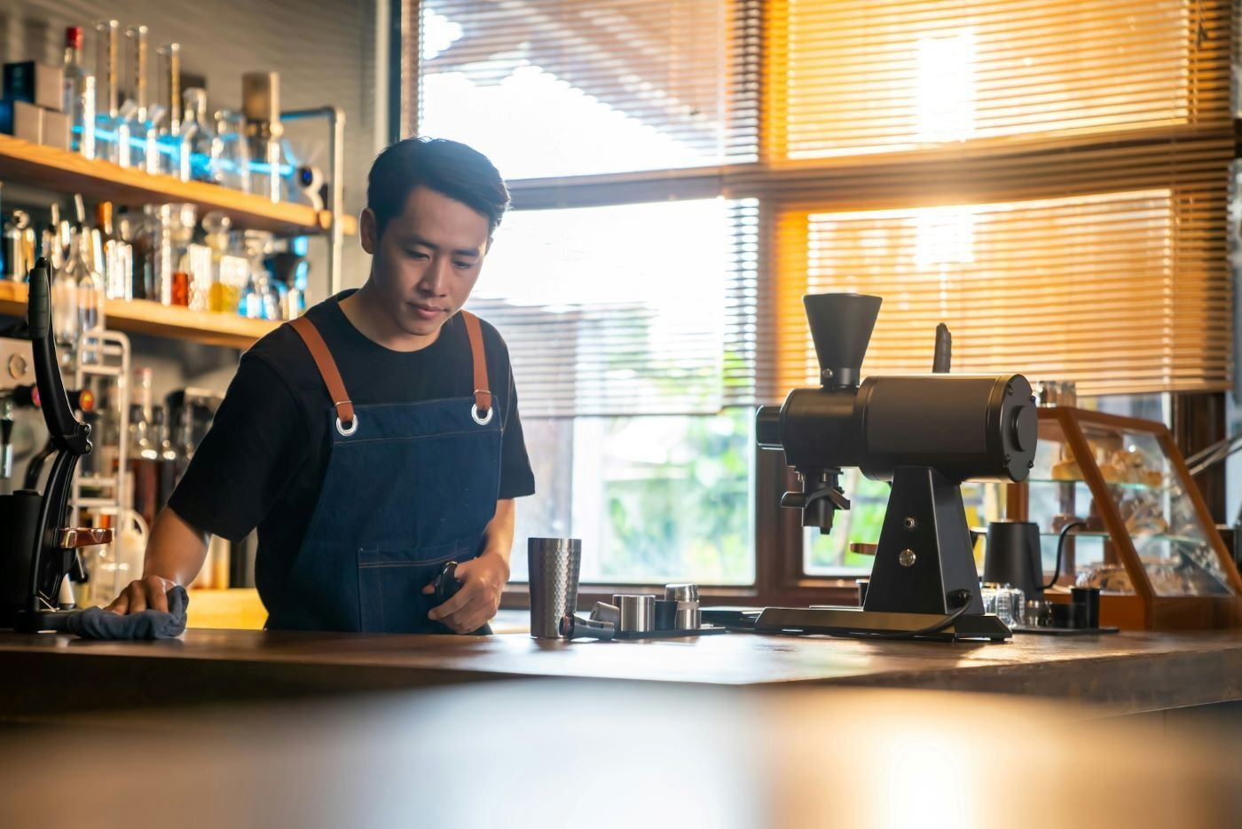 Coffee shop worker cleaning counter