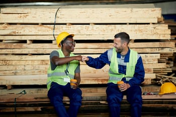 Construction workers fist bumping