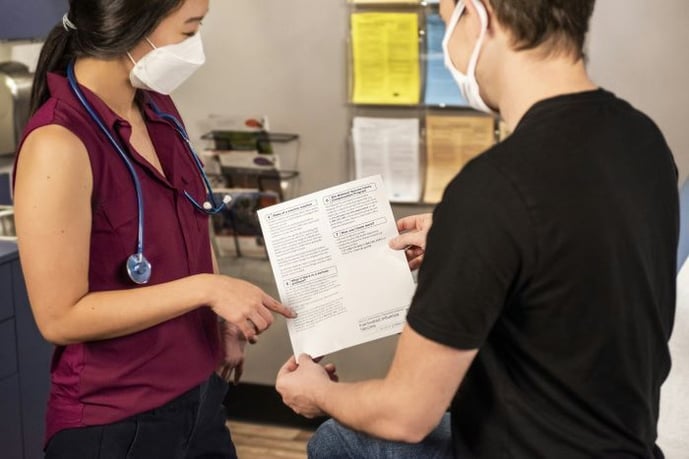 Healthcare during the pandemic, provider and patient wearing masks