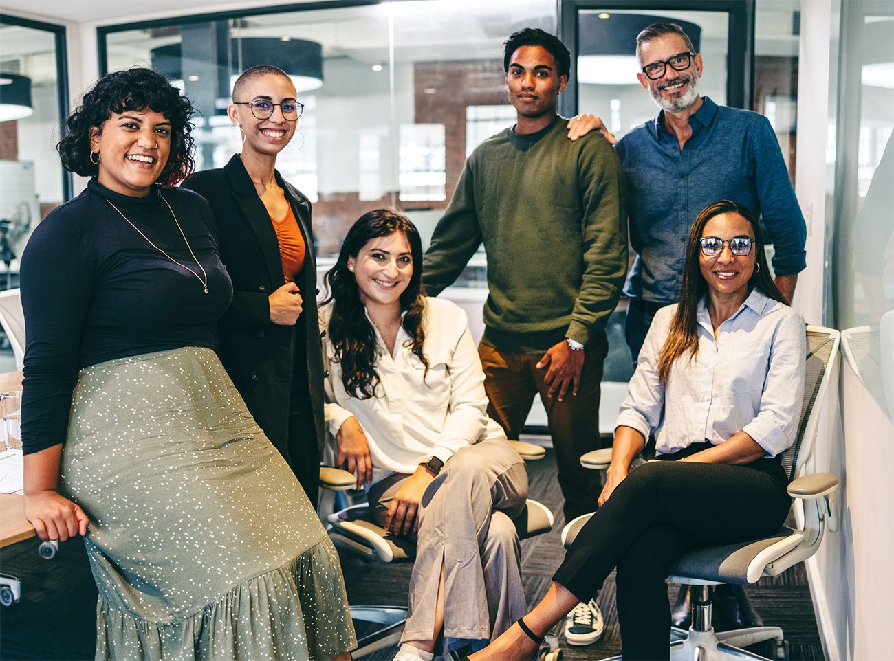 Team of businesspeople smiling at the camera in a boardroom-1