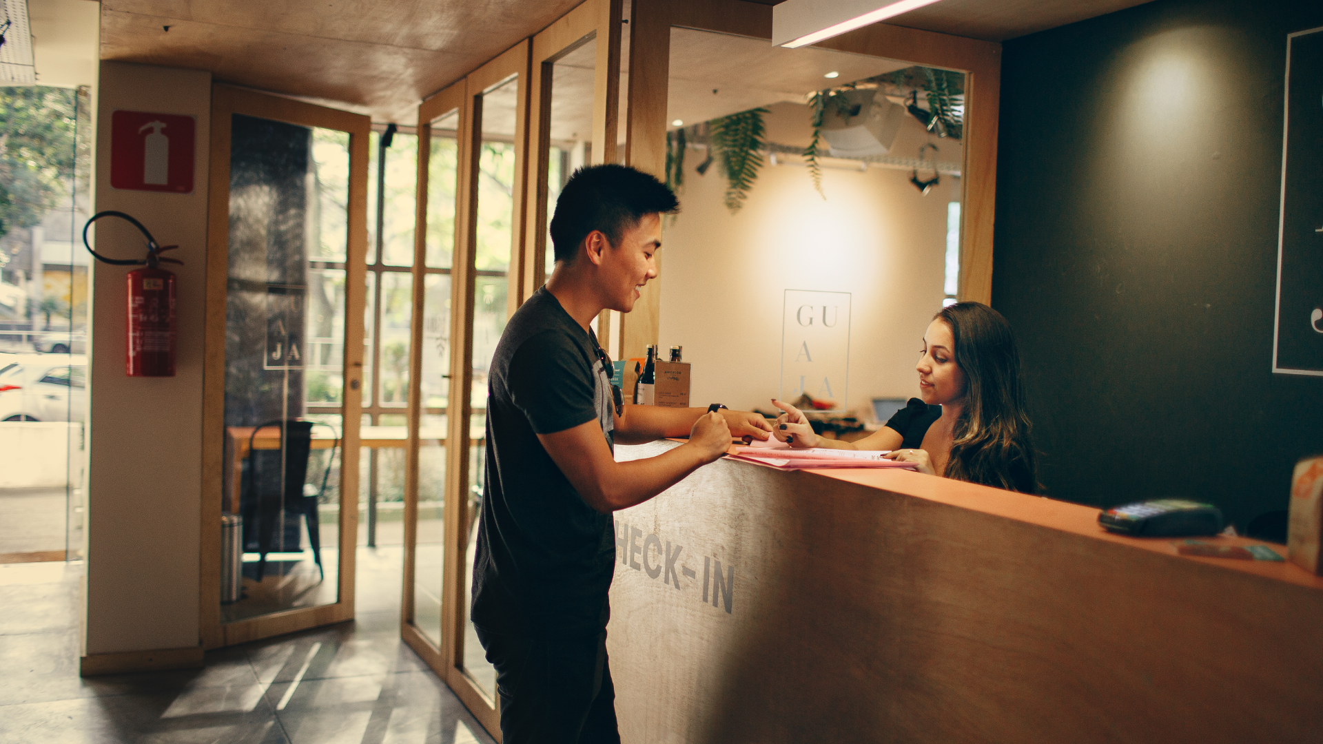 Hotel front desk teammate with customer 1