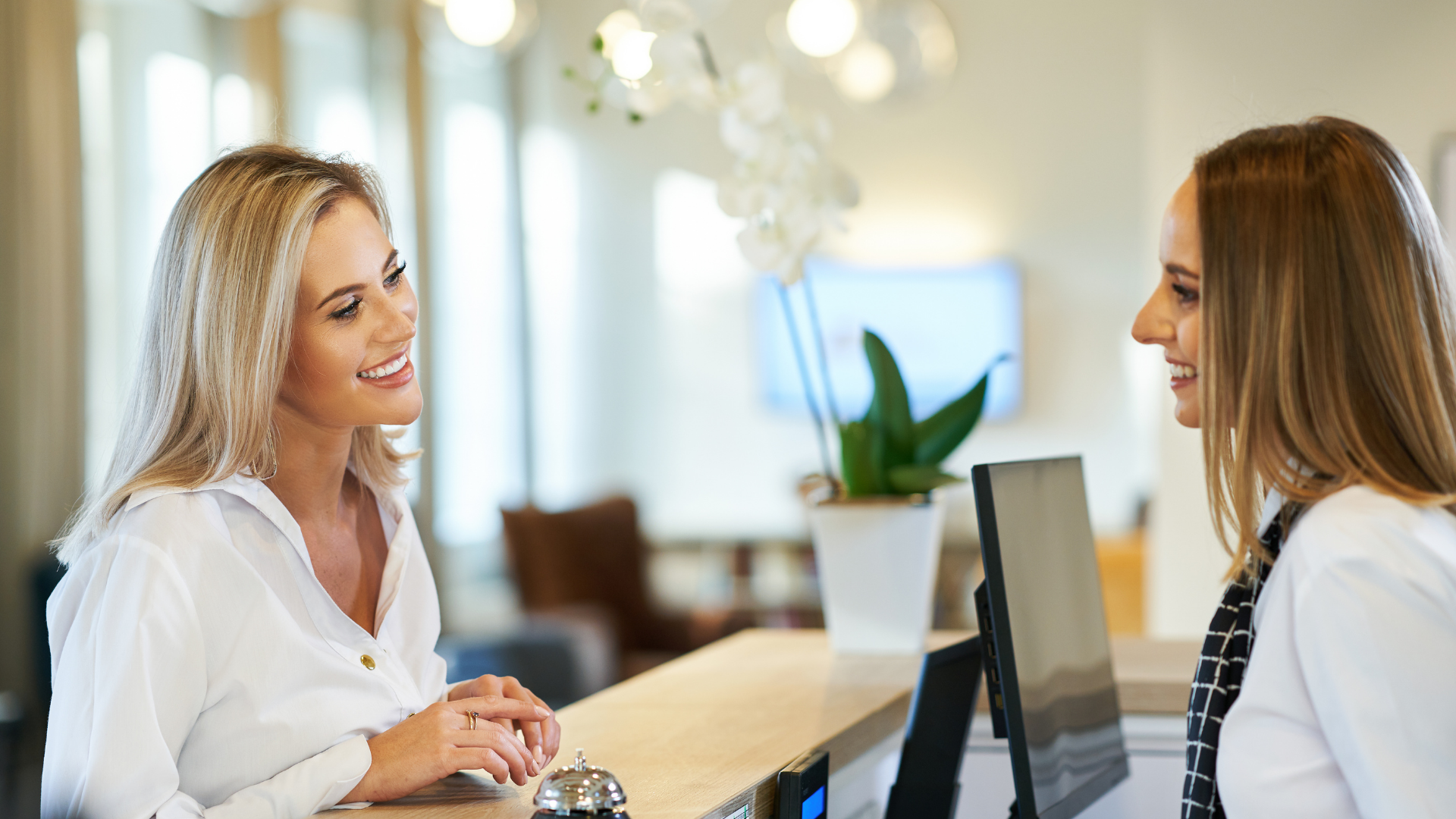 Hotel front desk teammate with customer 2