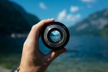 Lens pointed at mountains and lake