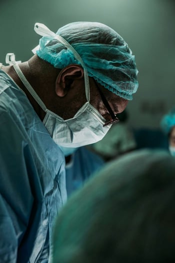 Male surgeon performing surgery
