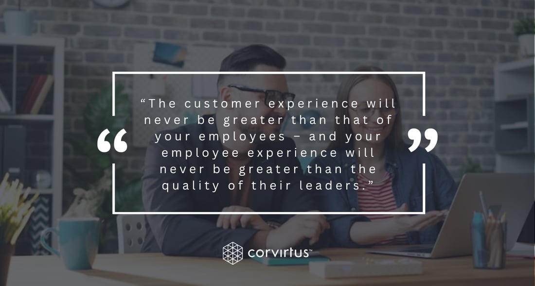 Pillar Quote - Two coworkers talk through work together at an open-plan office desk