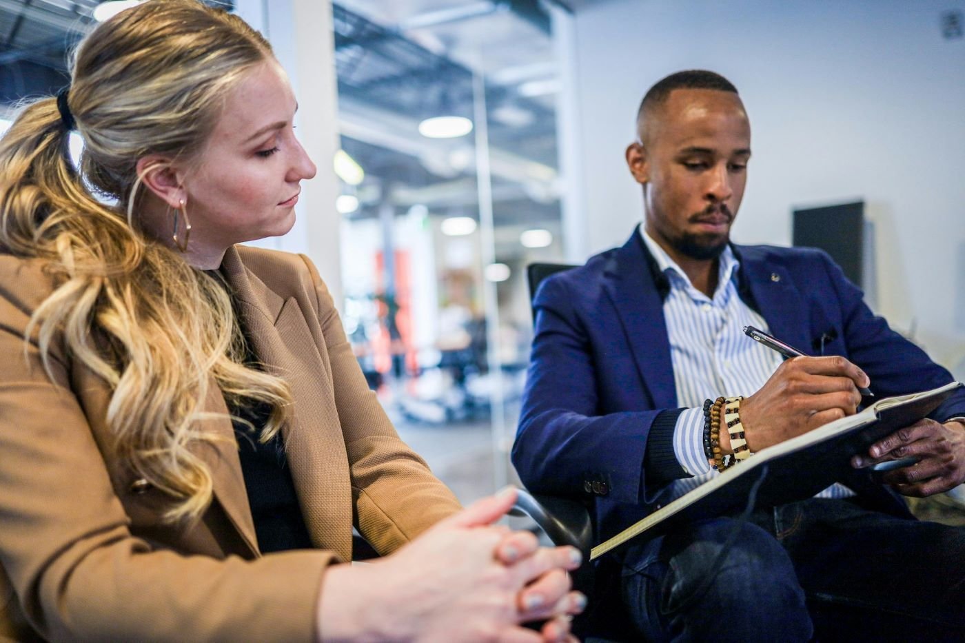 Two coworkers sitting and talking