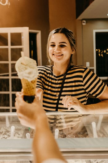 Woman being handed an ice cream