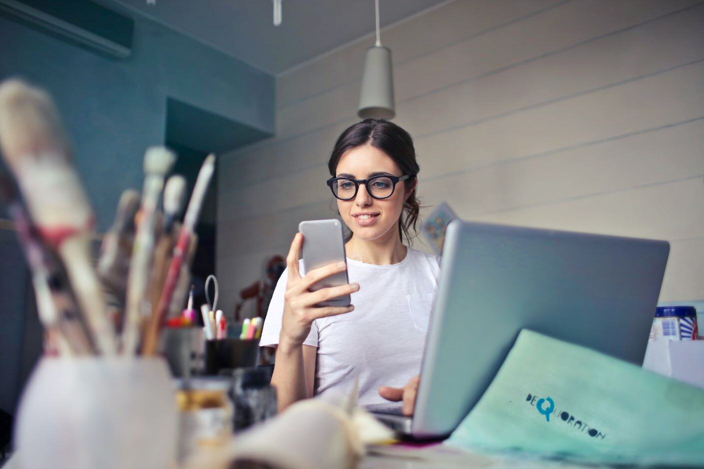 Woman in white shirt using smartphone