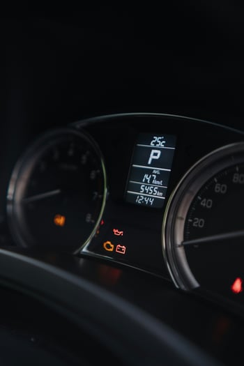 Car dashboard with check engine and alert lights illuminated; mirroring concerns about talent metrics.
