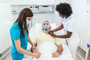 Healthcare workers providing patient care bedside