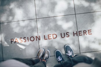 Feet on floor with words Passion Led Us Here