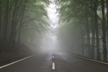 Road in fog with clouds, uncertain environment