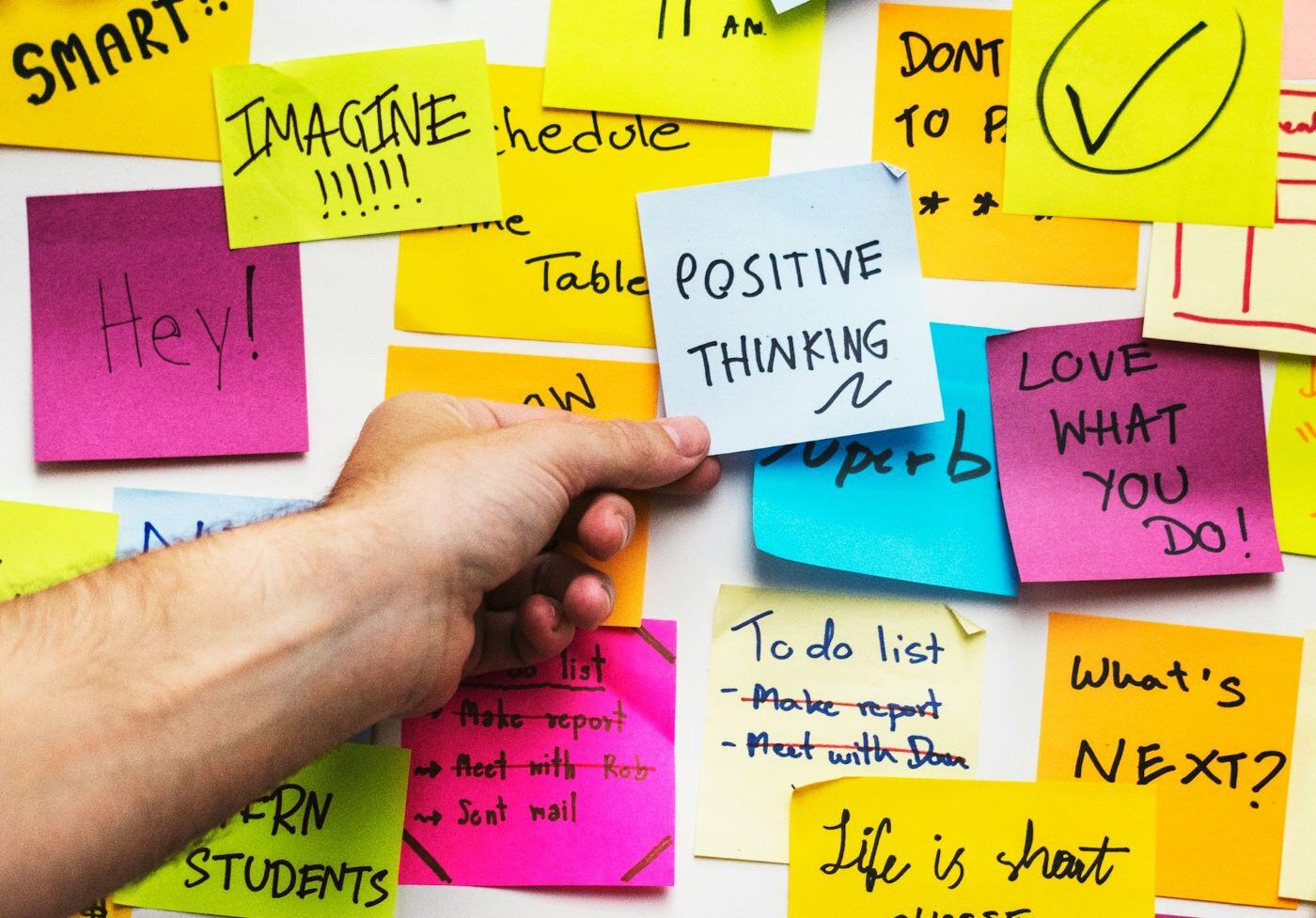 A wall of sticky notes with positive, encouraging messages